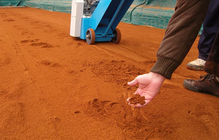 Red clay sport surfaces maintenance with excessive layer